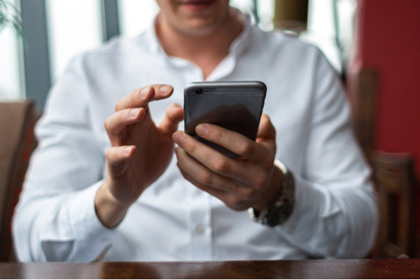 man using iphone